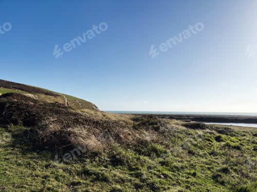 Preview: Coastal landscape at Seven Sisters Cliffs in East Sussex with blue sky and sea horizon
