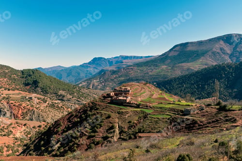 Preview: Breathtaking view of Morocco's Atlas Mountains with terraced fields and rustic homes