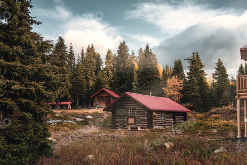 Preview: Wooden huts with sunshine in autumn forest on morning at Assiniboine provincial park