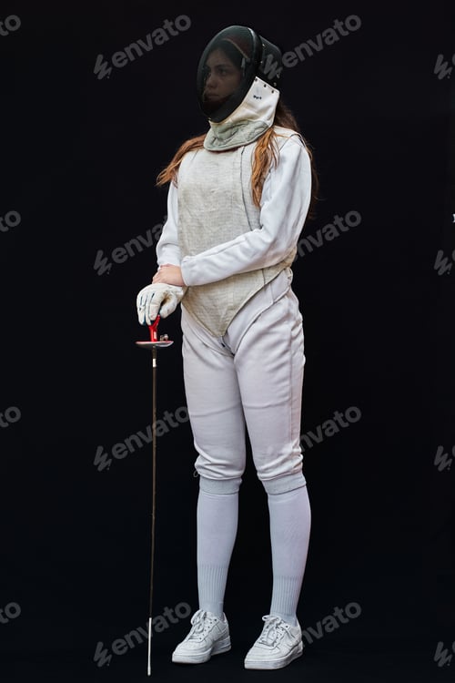Preview: Portrait of woman dressed in fencing costume on black background