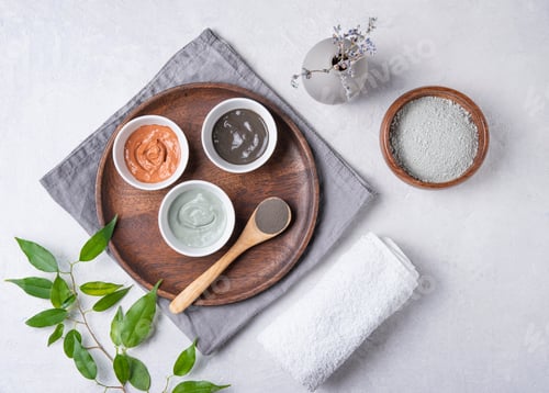 Vista previa: several types of cosmetic clay pink, green and gray with lavender on a gray concrete background