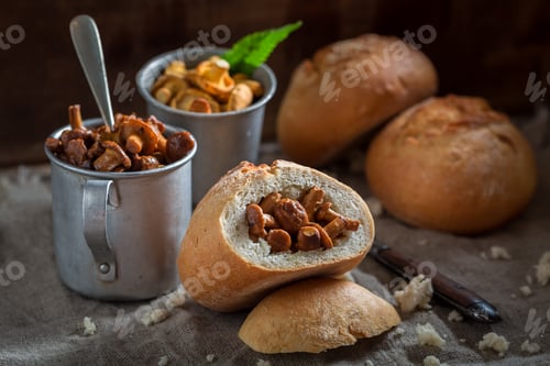 Preview: Ready to eat bun with mushrooms on old wooden table