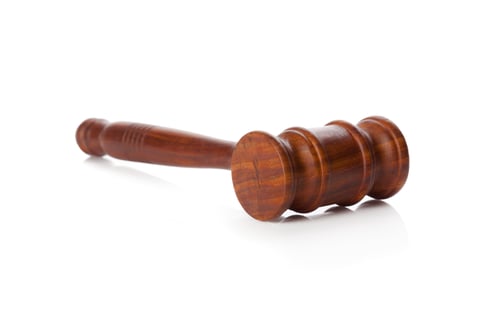 Preview: Wooden gavel placed on white surface for use in court or meeting setting