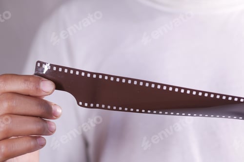 Preview: holding a camera with film rolls close up