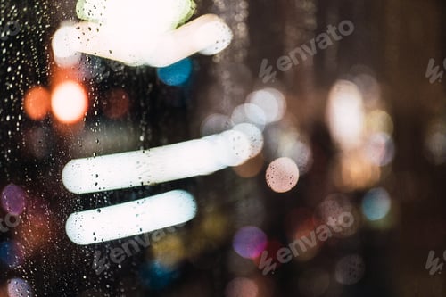 Preview: Night city through wet glass