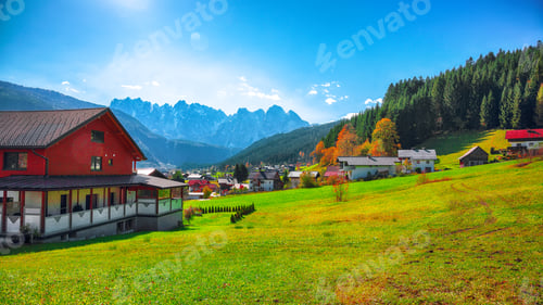 Preview: Alpine green fields and traditional wooden houses view of the Gosau village at autumn sunny day.