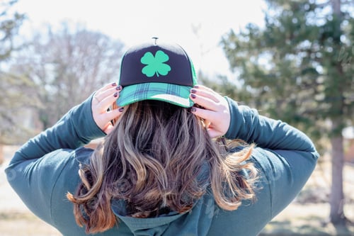 Preview: Young woman with long hair wearing a shamrock hat on St. Patrick’s Day
