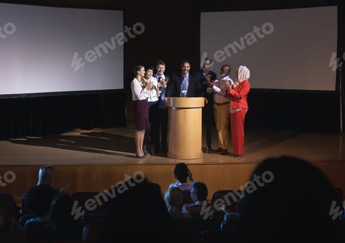 Preview: Business colleagues clapping hand for there colleague for the success in the auditorium
