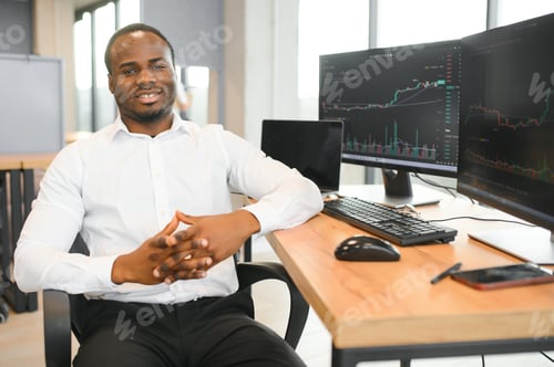 Preview: African-American broker works in office using workstation and analysis technology