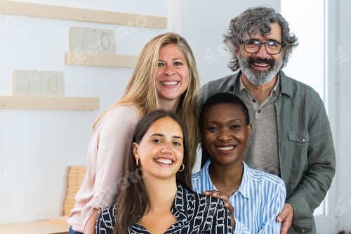 Preview: Cheerful diverse coworking women looking at camera