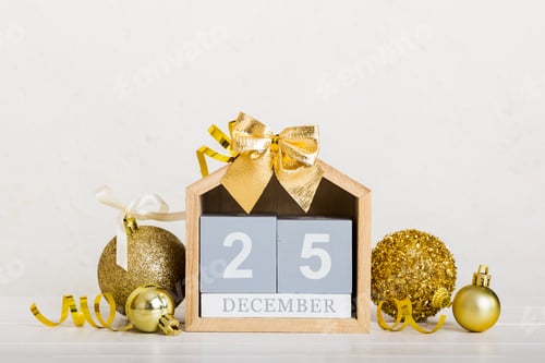 Preview: 25 december. Christmas composition on colored background with a wooden calendar,
