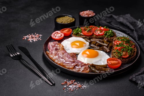 Preview: Tasty breakfast consists of eggs, bacon, beans, tomatoes, with spices and herbs