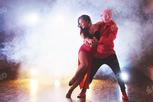 Preview: Skillful dancers performing in the dark room under the concert light and smoke