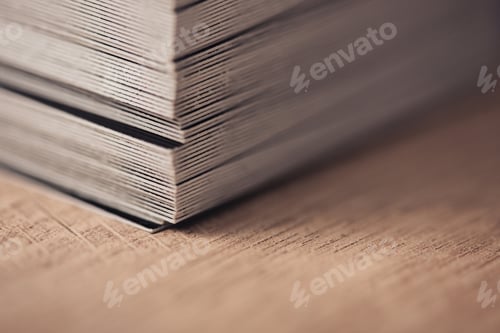 Preview: selective focus of business cards stacked on wooden surface
