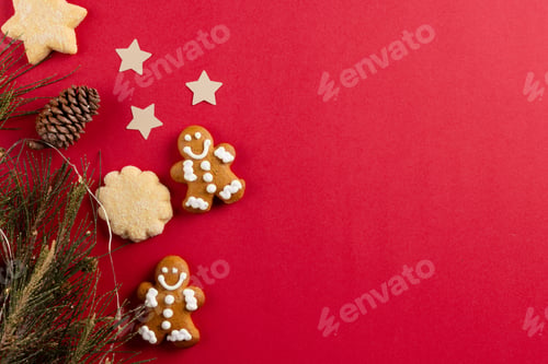 Preview: Image of gingerbread man biscuits and christmas decoration with copy space on red