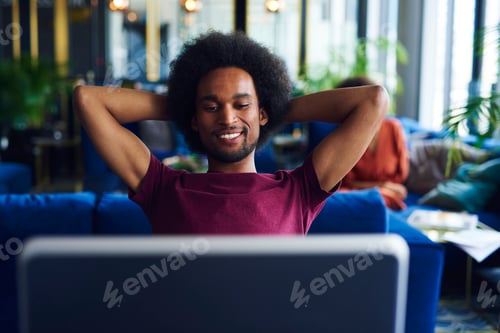 Preview: Satisfied African man relaxing in the office