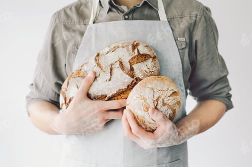 Preview: Baker or chef holding fresh made bread