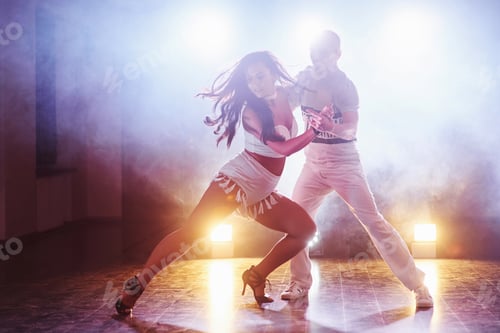 Preview: Skillful dancers performing in the dark room under the concert light and smoke