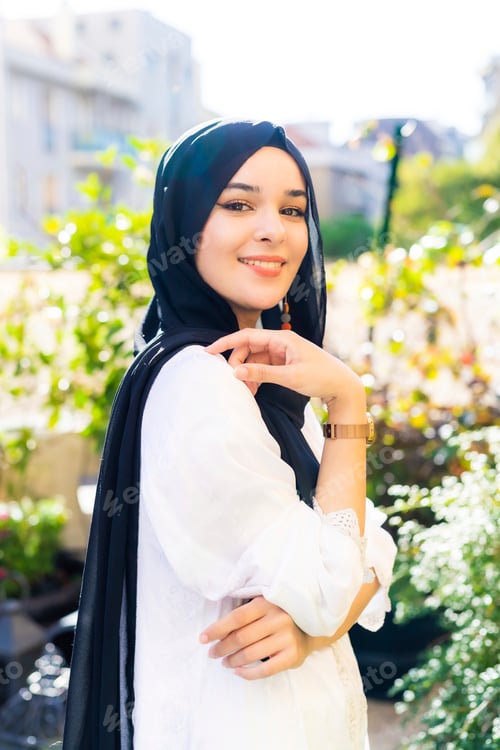 Preview: Elegant woman posing in a sunny garden