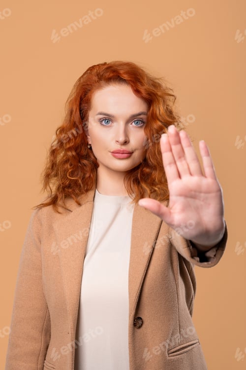 Preview: Ginger Businesswoman With Palm In Stop Gesture, Clear Assertive Body Language