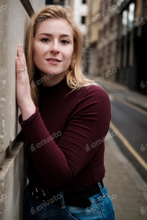 Preview: Portrait of young woman posing in a very narrow street.