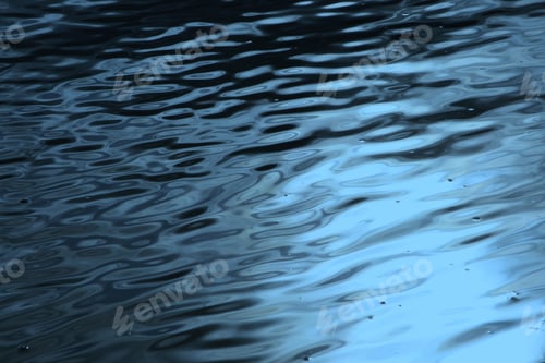 Preview: Dark blue wavy water surface with light glare