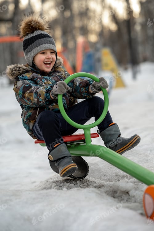 Preview: The baby laughs and swings on the swing, the child is on the playground