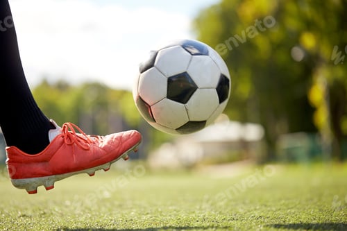 Preview: soccer player playing with ball on football field