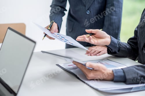 Preview: Business people meeting analyzing financial documents at meeting.