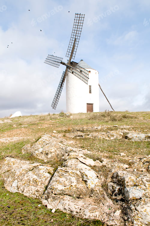 Preview: Vertical shot of a typical Spanish windmill on a cloudy day in Campo de Criptana, Spain