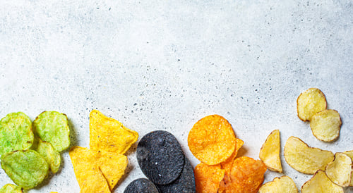 Preview: Different types of colored potato chips, gray background, copy space. Fast food concept.