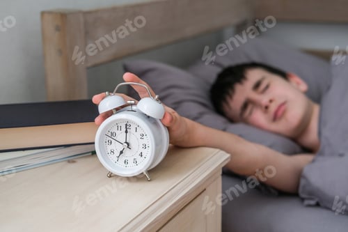Preview: The disgruntled boy reaches for the alarm clock. Morning of the schoolboy