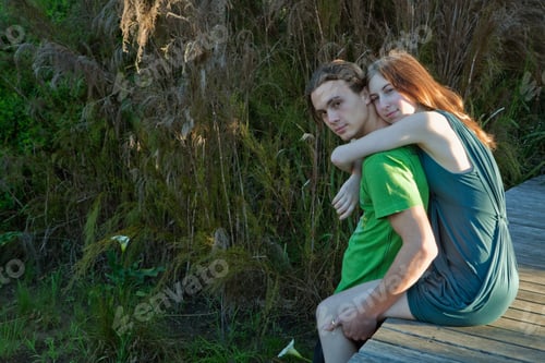 Preview: Girl on boardwalk with arms around man