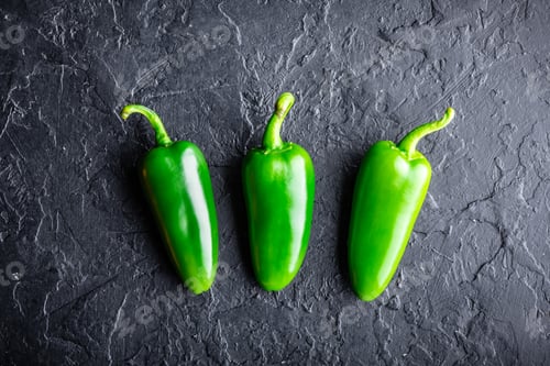 Preview: Green jalapeno hot pepper in wooden plate
