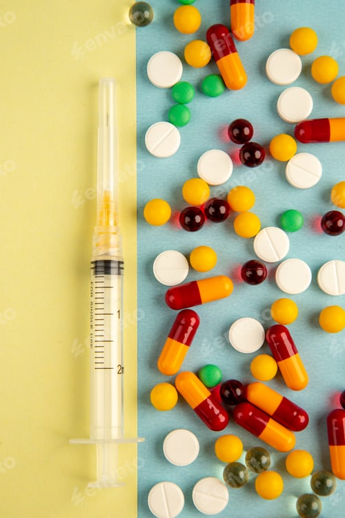 Preview: top view different pills with injection on colored background health pandemic hospital covid-
