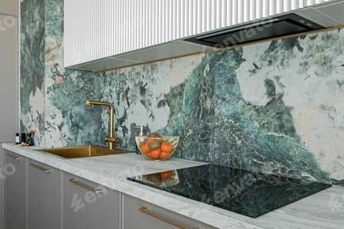 Preview: Grey kitchen table top with electric stove with a hood and sink, against a green marble tiled wall