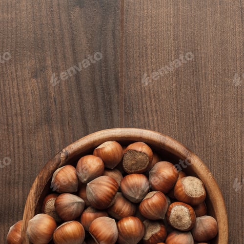 Preview: Hazelnuts In Wooden Bowl On The Brown Table