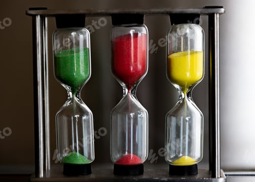 Preview: Close up of a colorful hourglass timers, green red and yellow