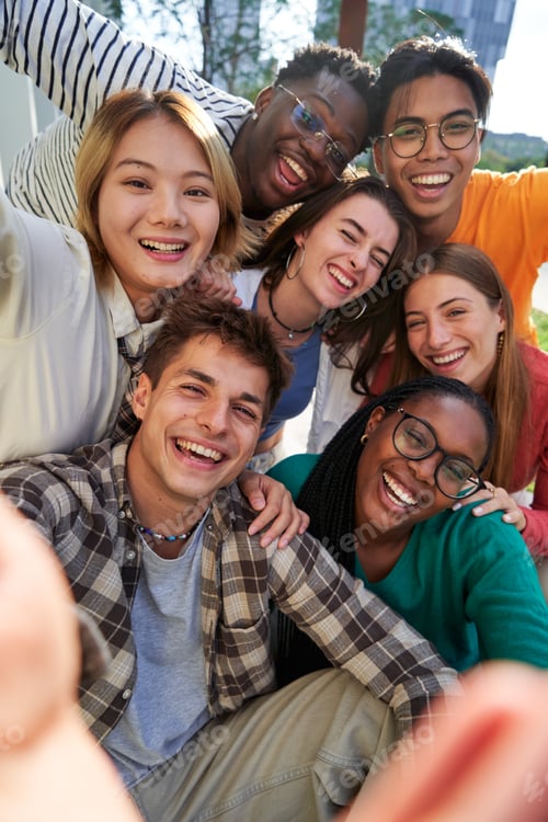 Preview: Multiethnic classmate taking a selfie outside of the university, looking at camera cheerfully.