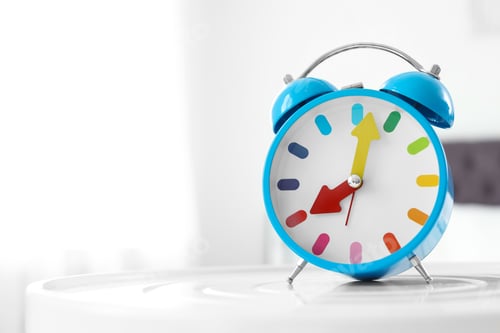 Preview: Colorful alarm clock on table in bedroom. Time to wake up