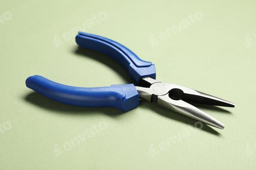 Preview: Needle nose pliers on olive background, closeup