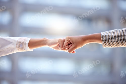 Preview: Shot of two unrecognizable businesspeople giving each other a fist bump against a city background