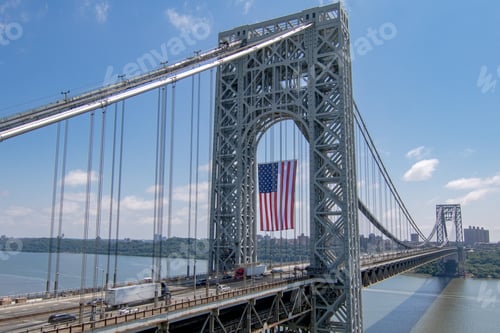 Preview: Bright morning at the George Washington Bridge in Fort, USA with the US flag hanging from it