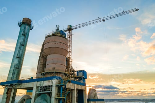 Preview: Aerial view of cement plant with high factory structure and tower crane