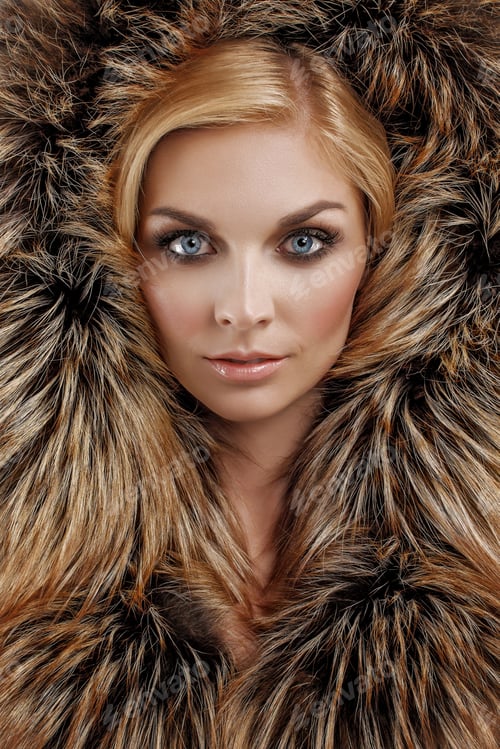 Preview: Attractive lady in black fur coat and hat. Perfect makeup, red mat lips and blue eyes.
