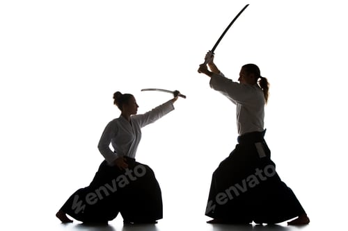 Preview: Man and woman fighting and training aikido on white studio background