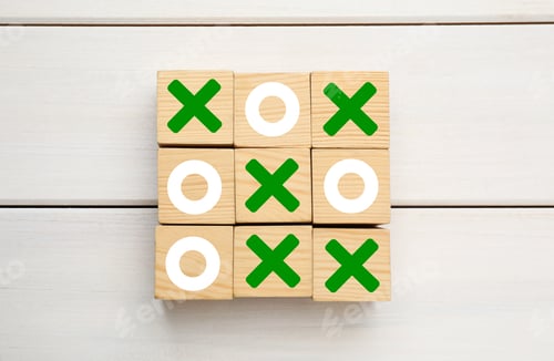 Preview: Tic tac toe cube set on white wooden table, flat lay
