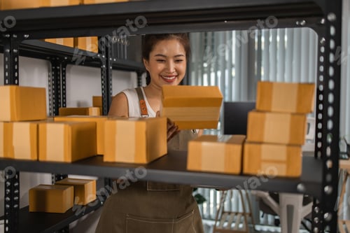 Preview: a packer checks the condition of a package before it is delivered to a customer