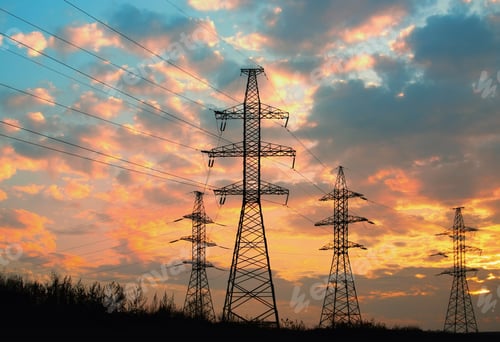 Preview: High voltage power transmission line. Silhouette electricity post on sunset background