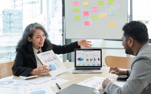 Preview: Business People Meeting using laptop computer,calculator,notebook,stock market chart paper for